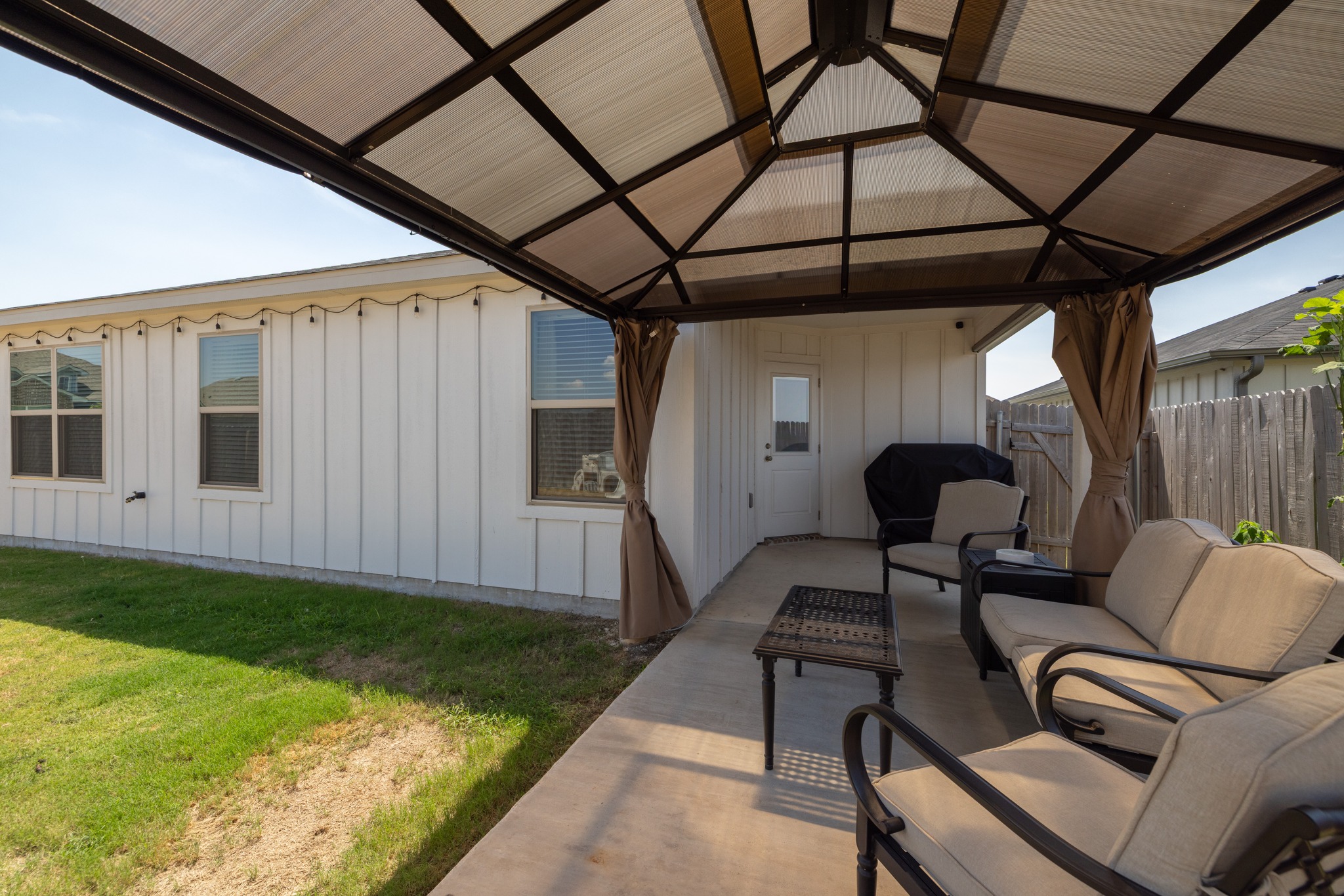 129 Maybelline Road Jarrell, TX 76537 - Photo 24 of 28 An inviting covered patio area transitions smoothly to the grassy backyard space.