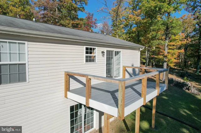 a view of house with backyard and seating area