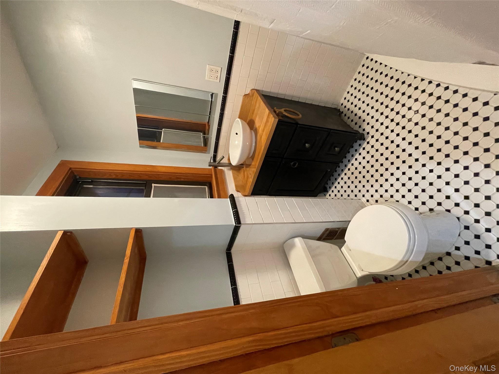 334 Locust Street Mount Vernon, NY 10550 - Photo 9 of 10 Bathroom featuring a wainscoted wall, tile walls, and vanity