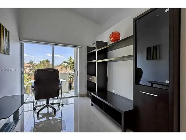 a living room with furniture and a lamp