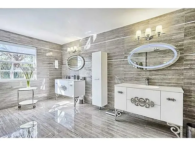 a bathroom with a sink a mirror and a shower