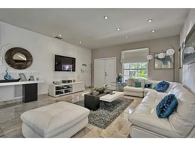 a living room with furniture and a flat screen tv