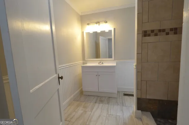 a bathroom with a sink and mirror