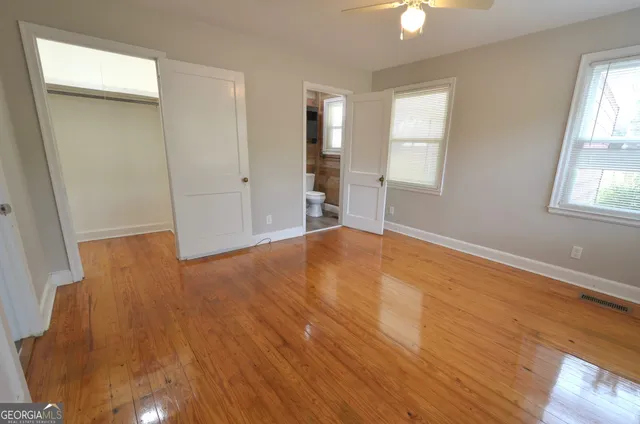 wooden floor in an empty room with a window