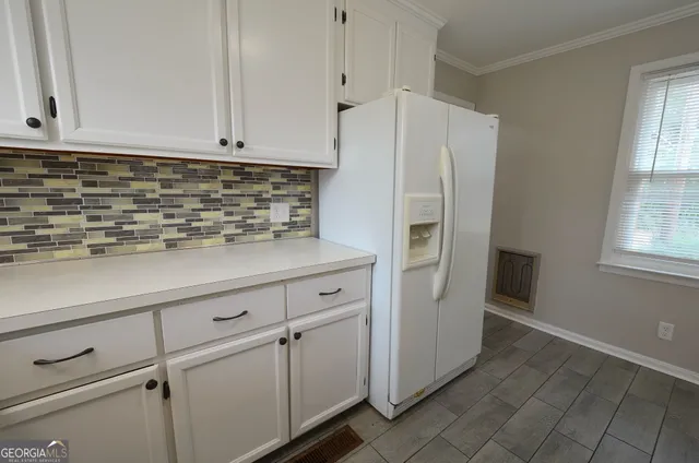 a white refrigerator freezer sitting inside of a kitchen