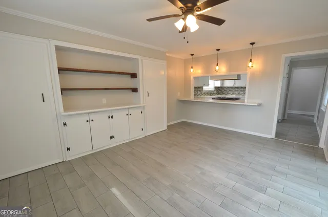 a view of a kitchen with an empty space and a window