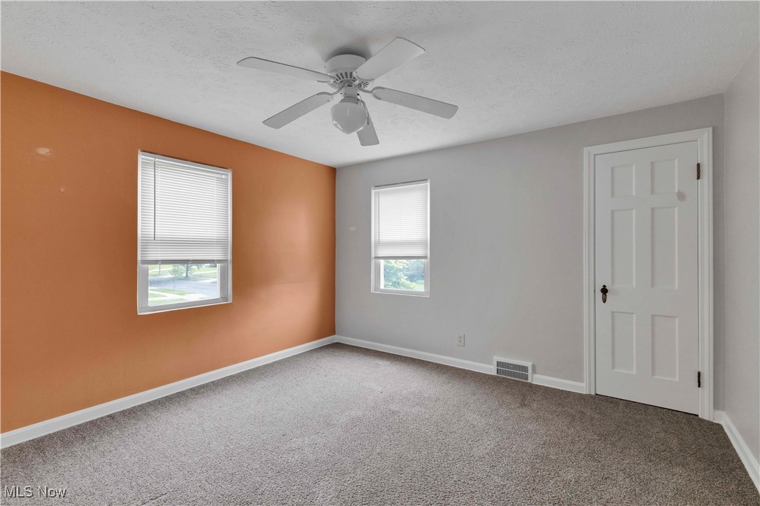 3385 Rosedale Road Cleveland, OH 44112 - Photo 22 of 40 Carpeted empty room with baseboards, ceiling fan, and a textured ceiling