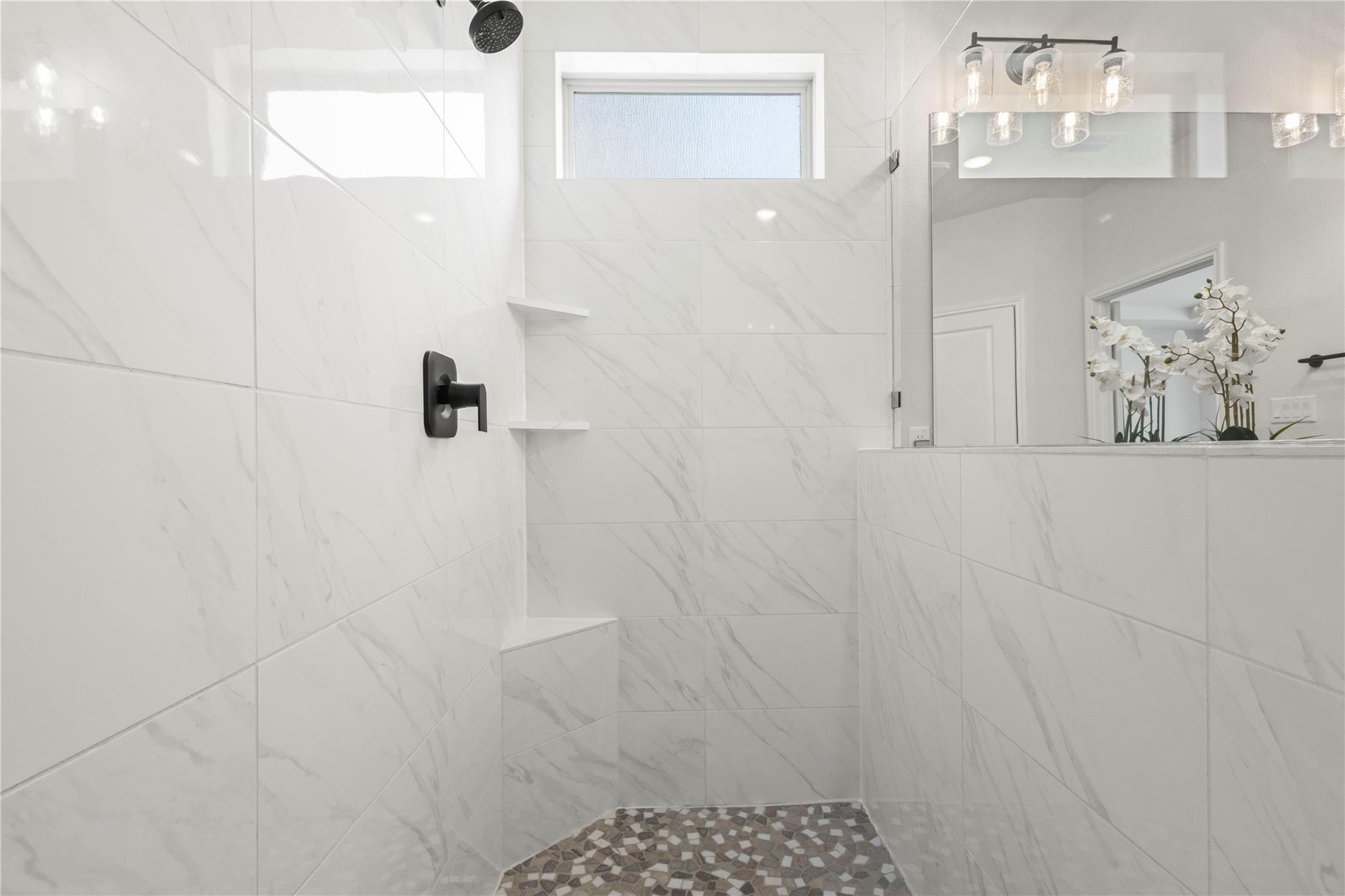 1128 Villa Rialto View Leander, TX 78641 - Photo 29 of 40 A well-appointed shower space, complete with tile flooring and a sleek overhead shower fixture.