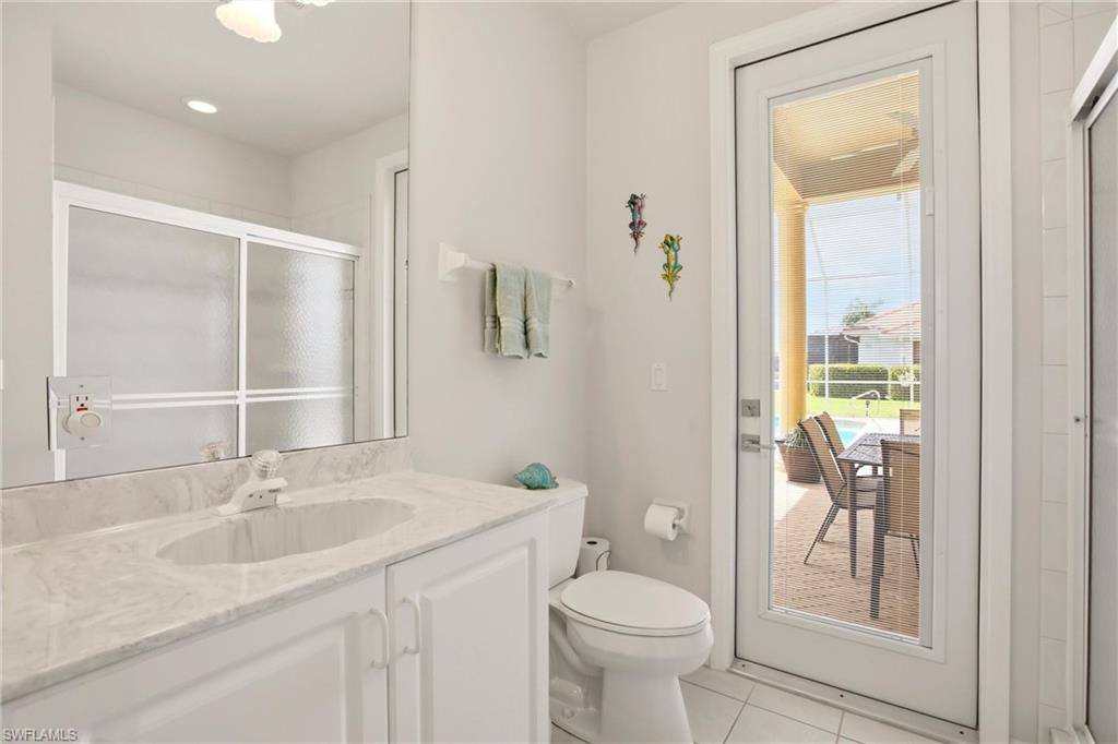 10815 Phoenix Way Naples, FL 34119 - Photo 26 of 40 a bathroom with a granite countertop sink toilet and shower