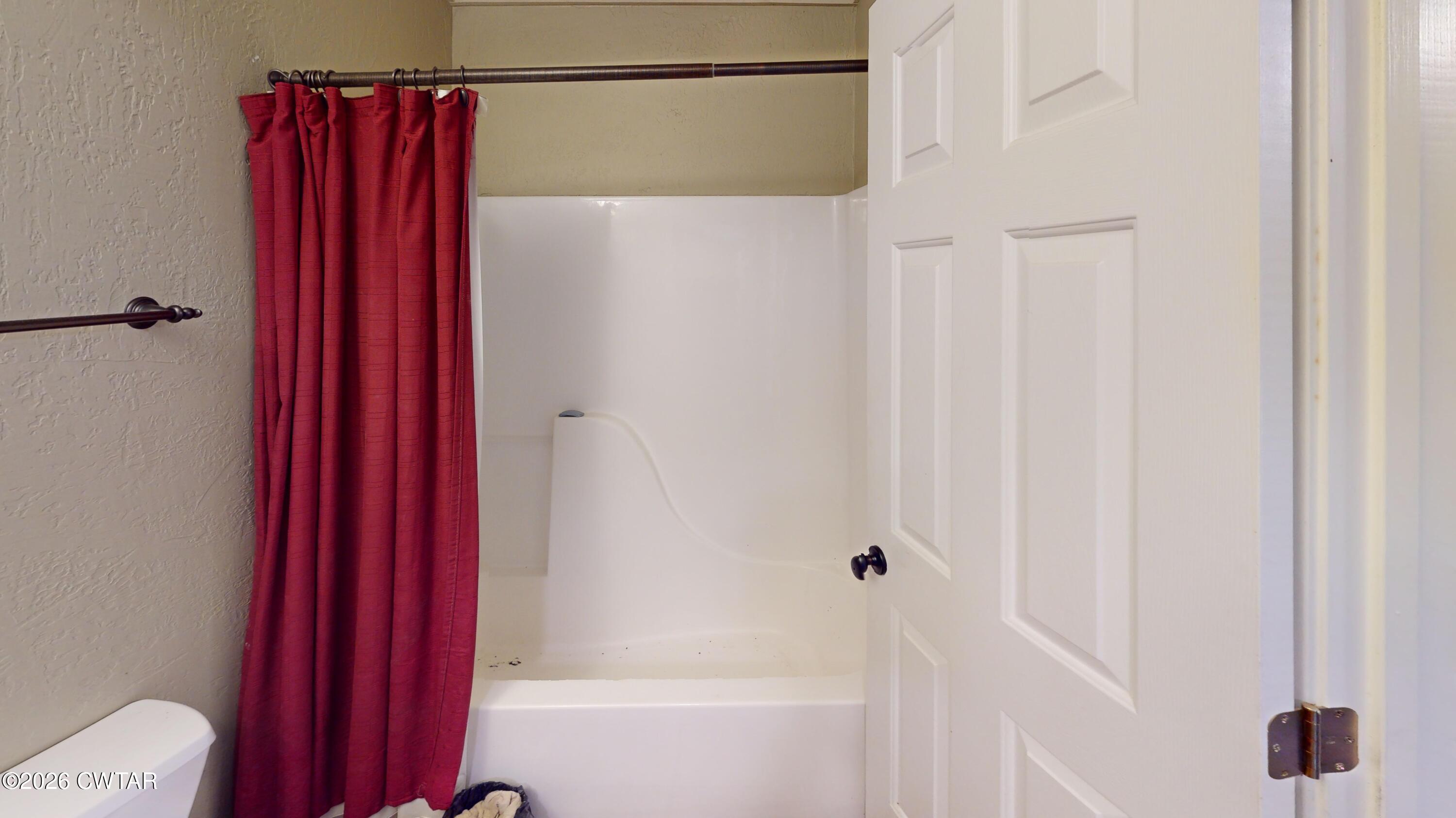 1532 Jackson Hill Road Hornbeak, TN 38232 - Photo 20 of 50 a bathroom with a shower curtain and a wooden floor
