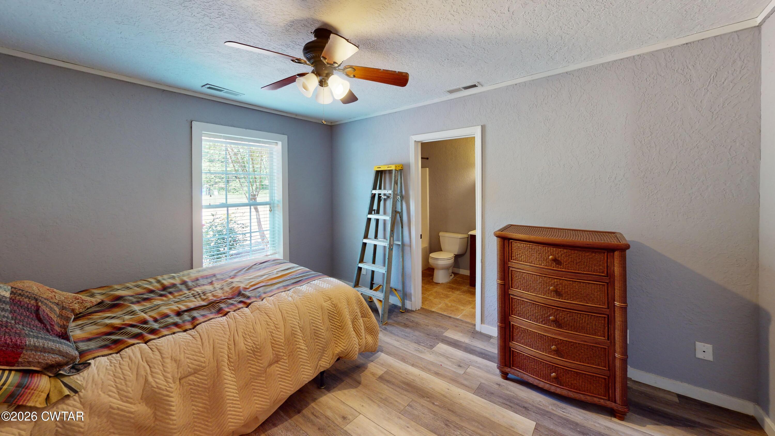 1532 Jackson Hill Road Hornbeak, TN 38232 - Photo 25 of 50 a bedroom with a bed and a dresser