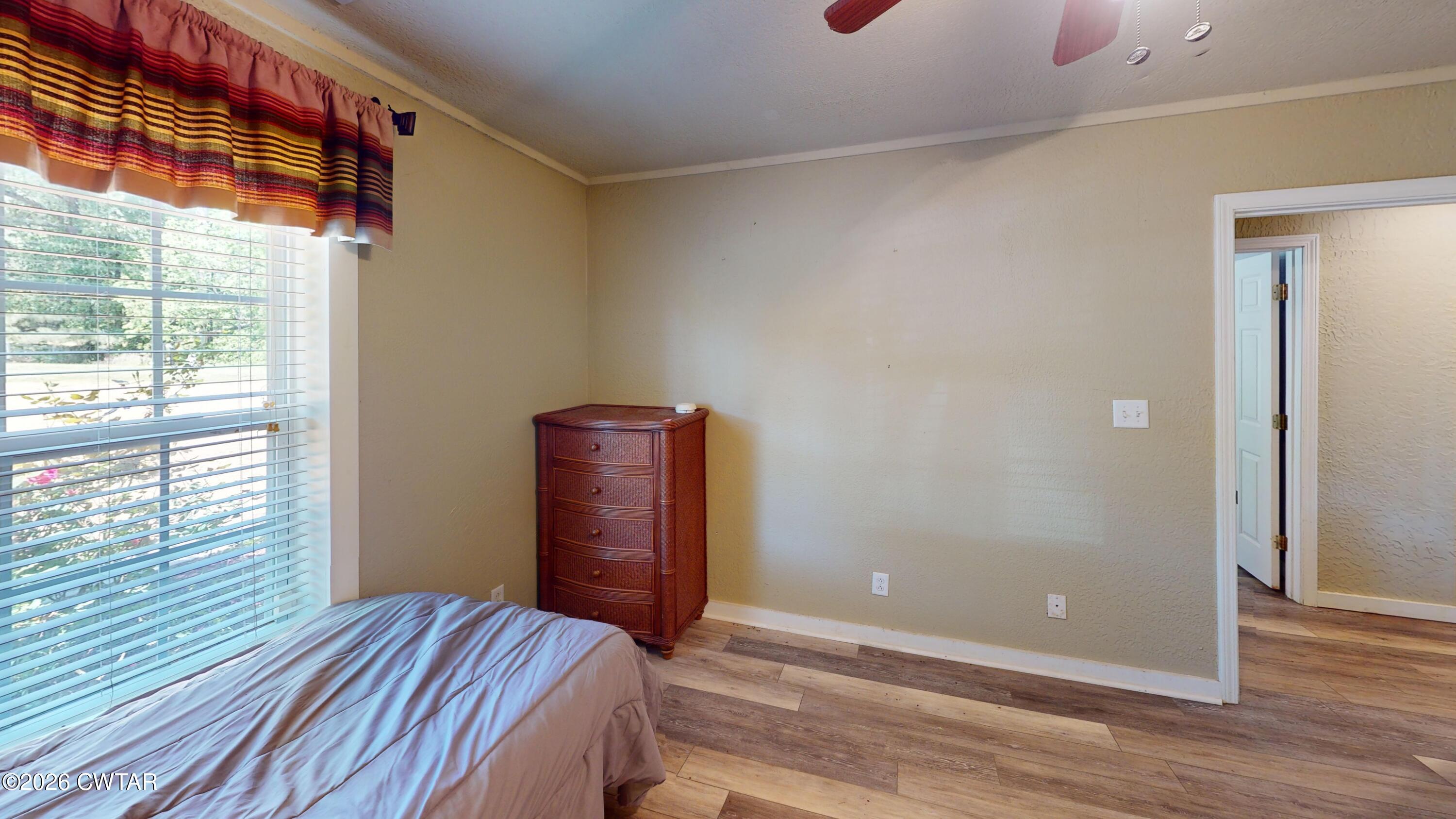 1532 Jackson Hill Road Hornbeak, TN 38232 - Photo 27 of 50 a view of a bedroom with wooden floor and windows