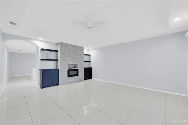 a view of a kitchen with a sink and a fireplace