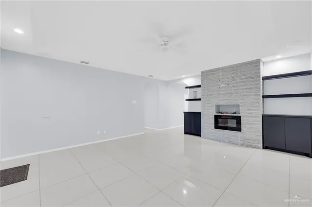 a view of an empty room with a kitchen