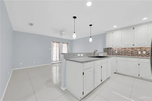 a view of kitchen with refrigerator sink and cabinets