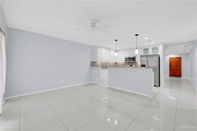 a kitchen with stainless steel appliances a refrigerator sink and microwave