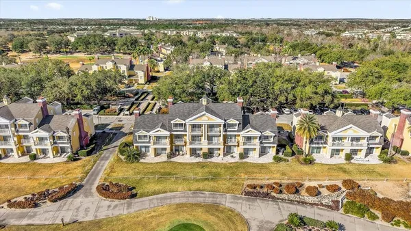 an aerial view of residential houses with outdoor space