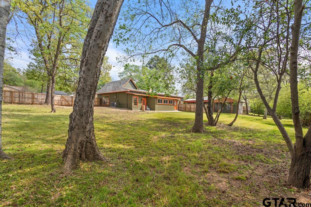 2819 New Copeland Road Tyler, TX 75701 - Photo 30 of 39 a blue swimming pool with a trees in the background