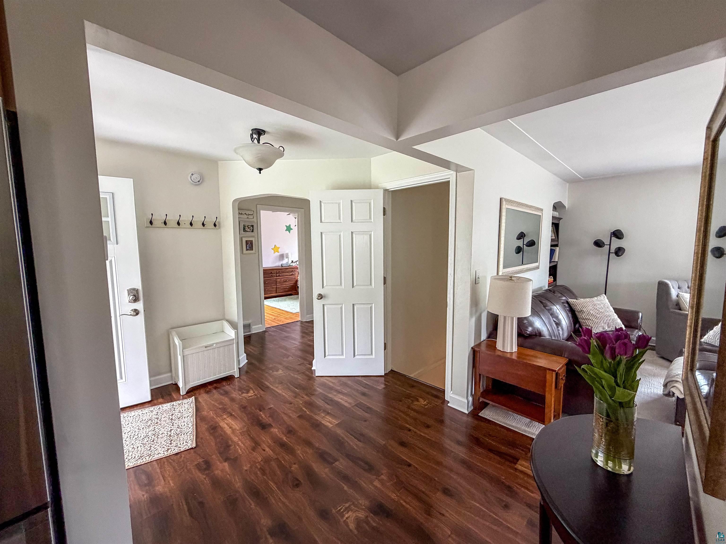 3704 Greysolon Road Duluth, MN 55804 - Photo 11 of 51 Spacious entryway featuring rich wood-finish flooring, white trim work, and a traditional flush mount light fixture