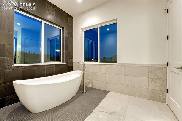 a white bath tub sitting in a bathroom