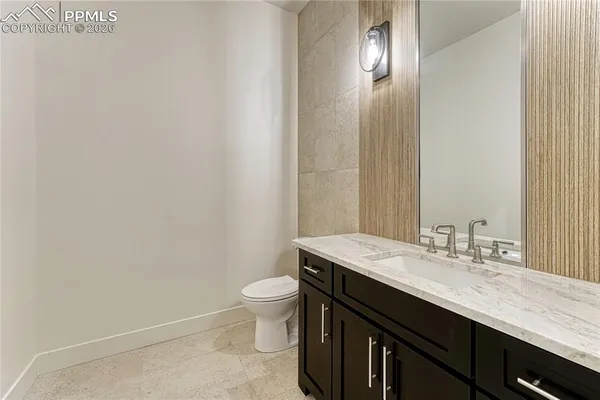 a bathroom with a sink a toilet and mirror