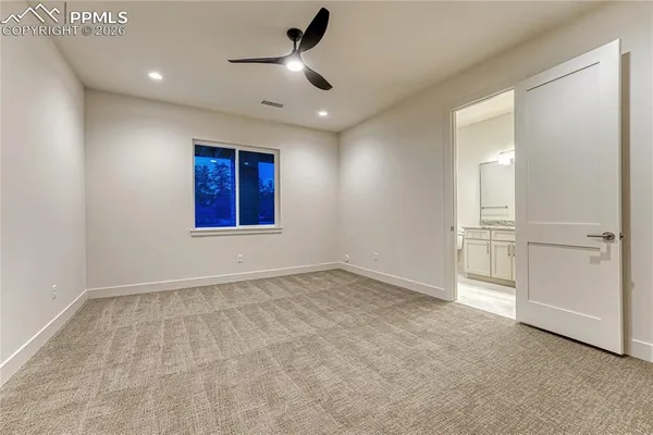 an empty room with closet and windows