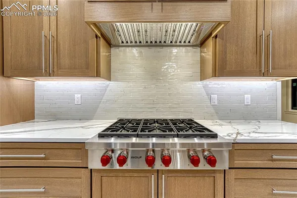 a kitchen with a stove and cabinets