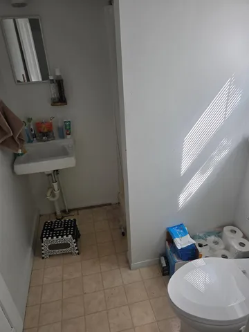 a bathroom with a sink toilet and a mirror