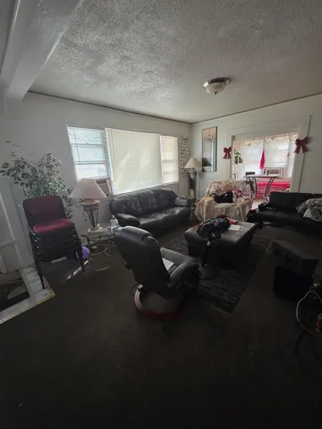 a bedroom with furniture and a rug