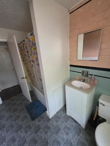 a living room with furniture chess board and a window