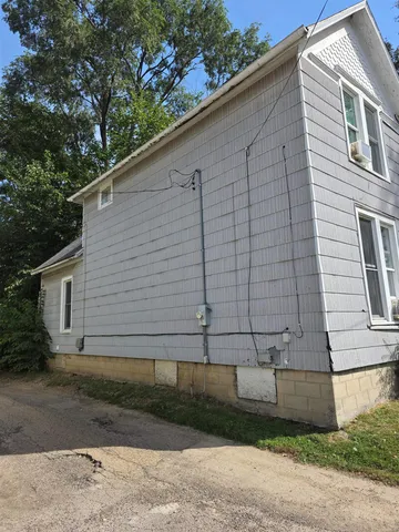 a side view of a house with a yard