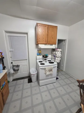 a kitchen with a stove a sink and a cabinets