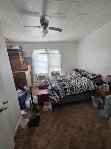 a bedroom with bed and window