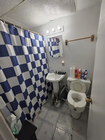 a bathroom with a sink toilet and a mirror