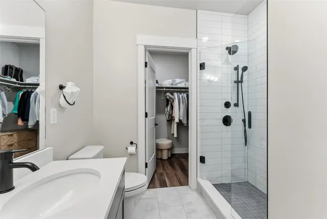 a bathroom with a sink toilet and shower