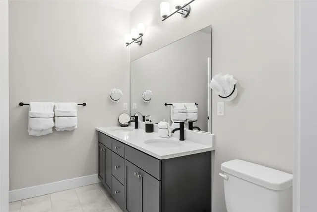 a bathroom with a sink vanity and a toilet