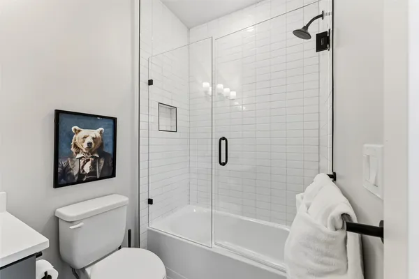 a bathroom with a toilet and a shower
