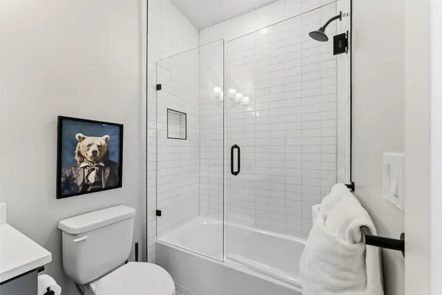 a bathroom with a toilet and a shower