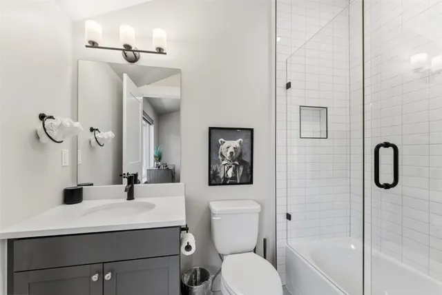 a bathroom with a toilet sink and shower