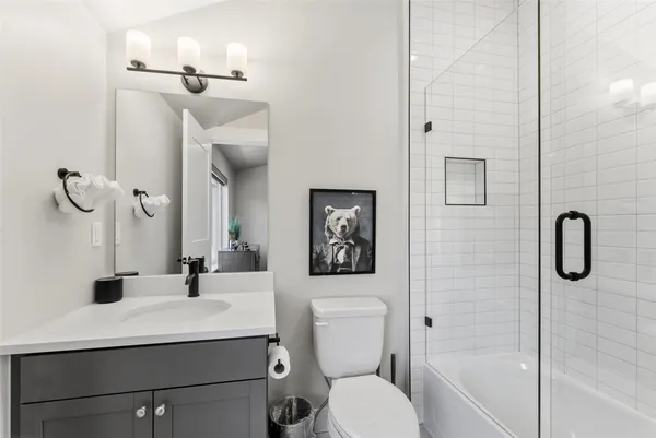 a bathroom with a toilet sink and shower