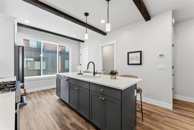 a view with a sink and mirror with wooden floor