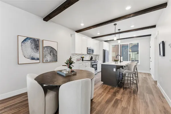 a dining room with furniture and wooden floor