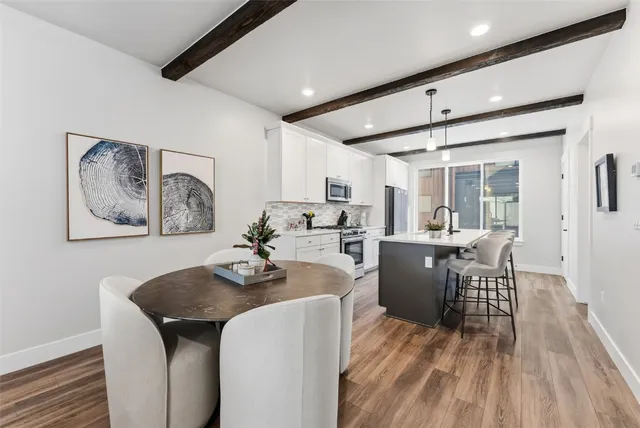 a dining room with furniture and wooden floor