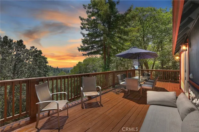 an outdoor sitting area with furniture and wooden deck