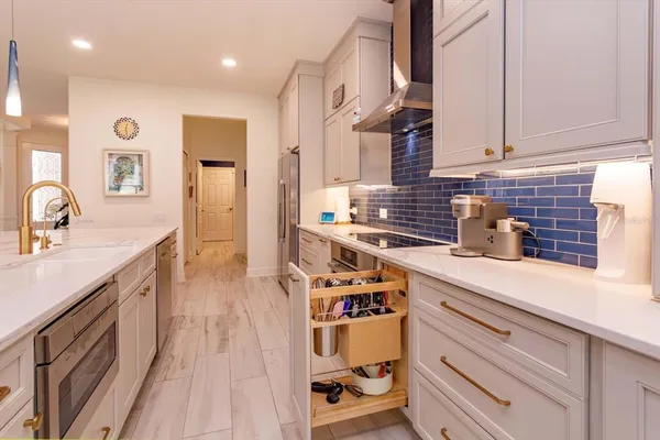 a kitchen with stainless steel appliances a sink stove and cabinets