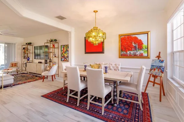 a view of a dining room with furniture wooden floor and chandelier