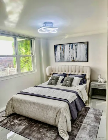 a bedroom with bed and window