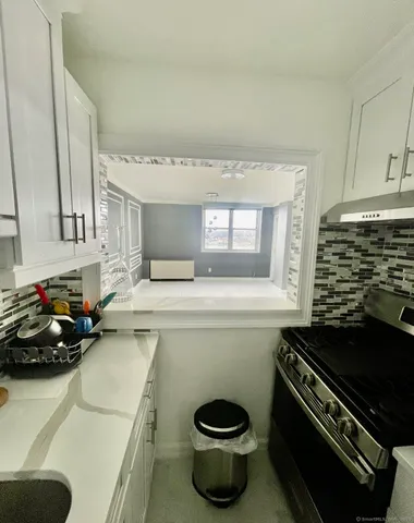 a kitchen with a stove a sink and a microwave