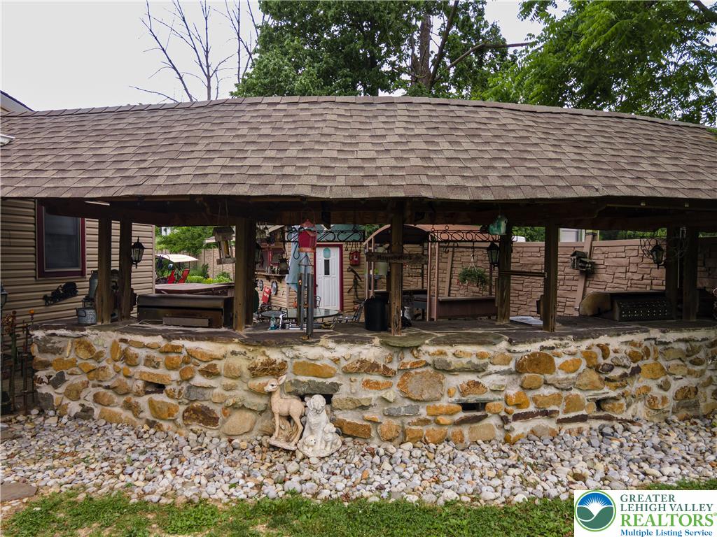 2485 Hieter Road Quakertown, PA 18951 - Photo 93 of 97 A charming, covered patio space features a rustic stone and concrete base, perfect for outdoor gatherings.