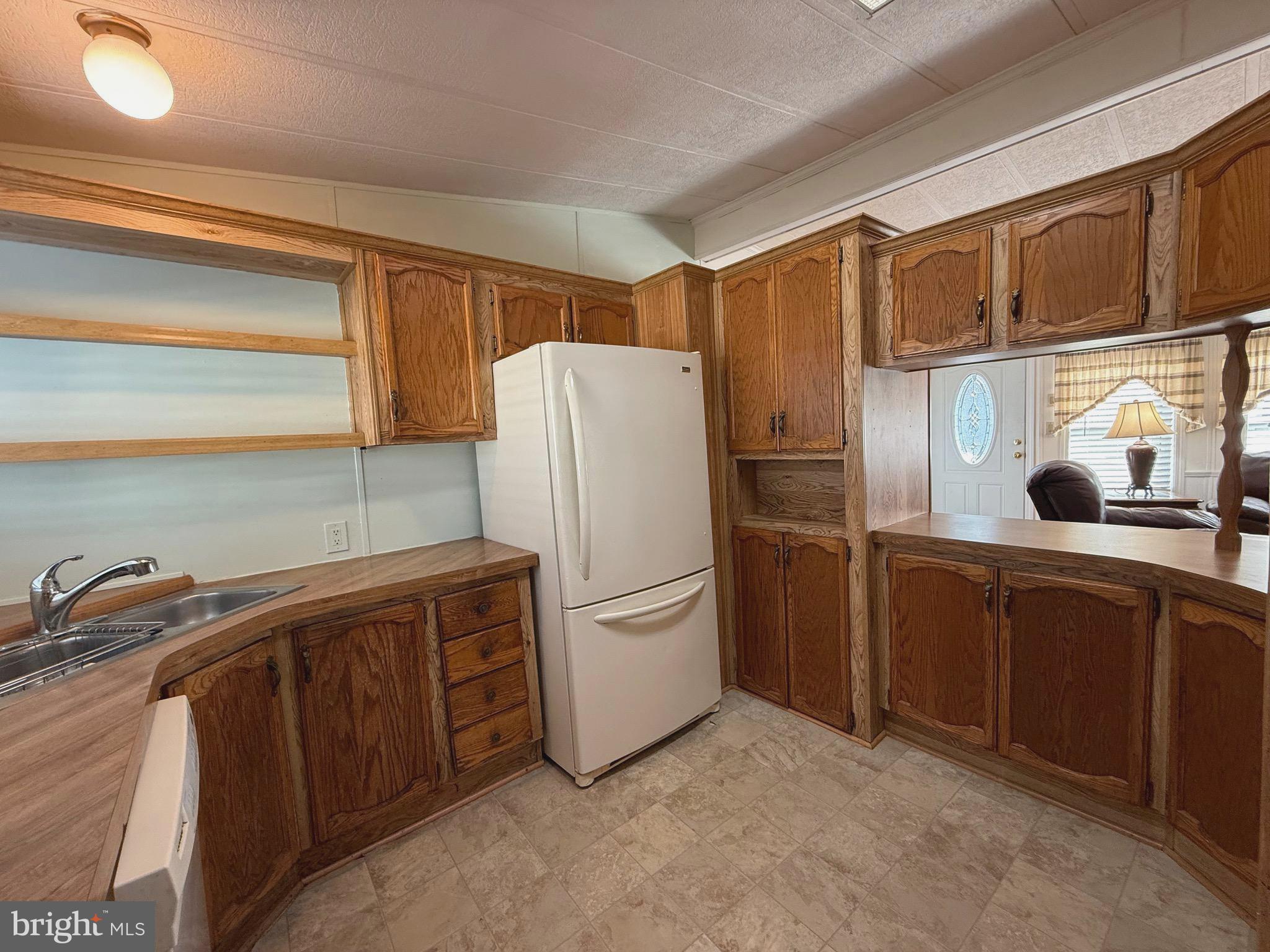 386 Indian Way Buena, NJ 08310 - Photo 7 of 53 a kitchen with stainless steel appliances a refrigerator and a sink